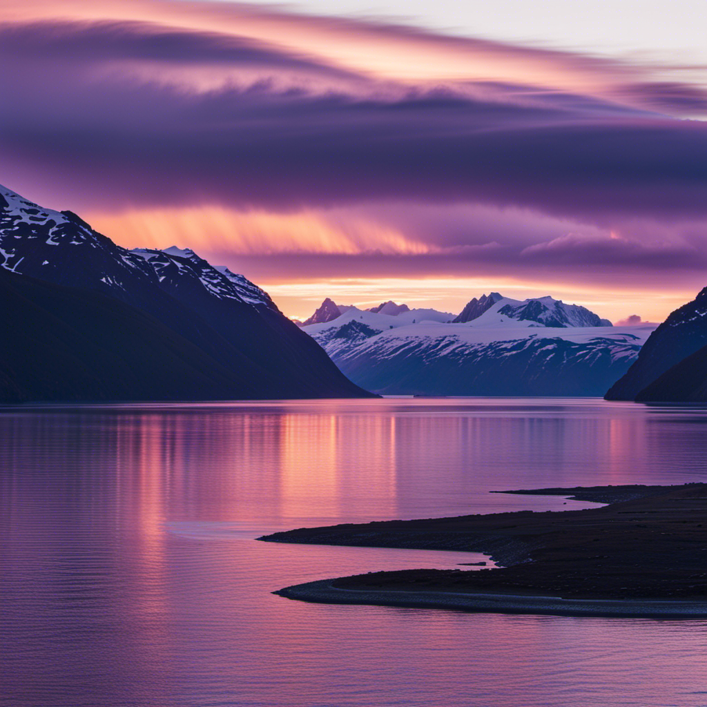 An image capturing the ethereal beauty of a radiant Alaskan sunset over a serene glacial fjord, enveloped in a dusky, purple haze, enticing readers to explore the allure of an Alaskan cruise
