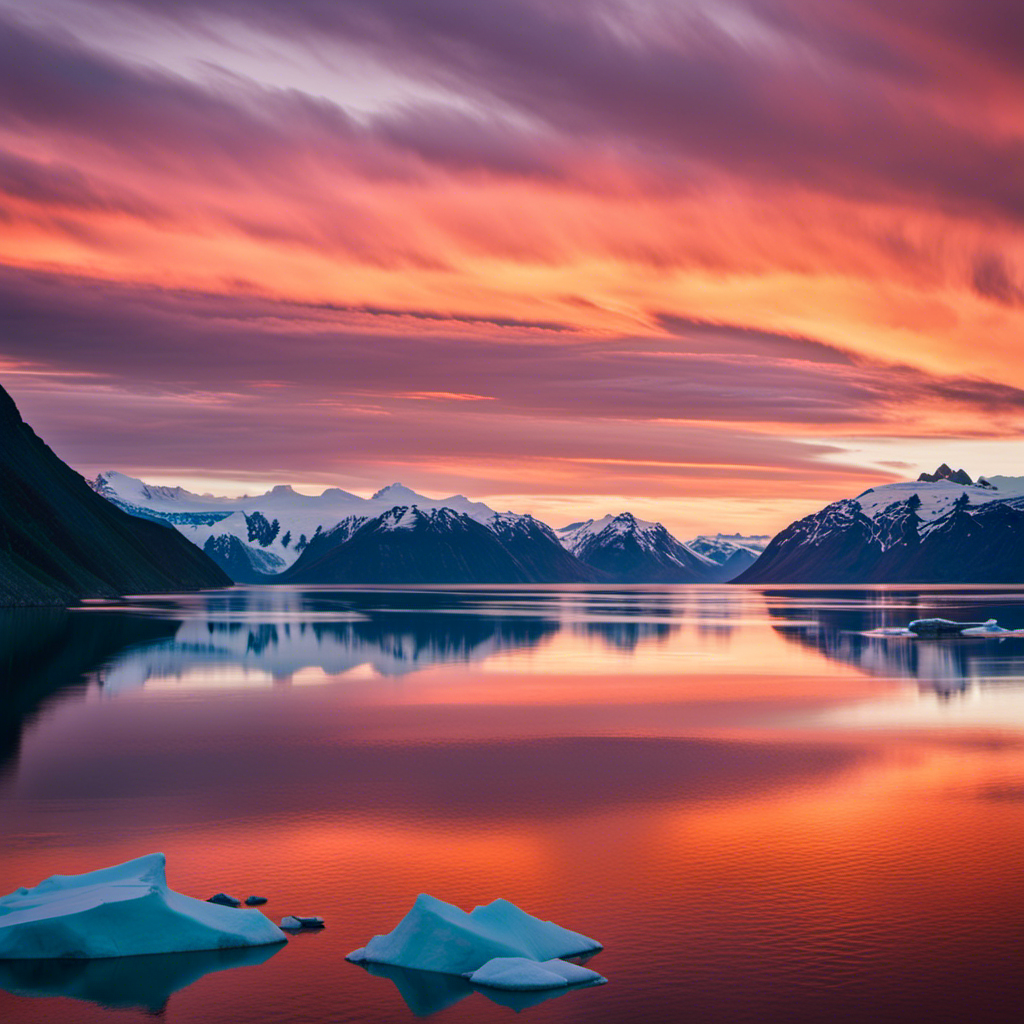 An image of a breathtaking sunset over a glacier-filled fjord in Alaska, where the sky is painted in hues of orange and pink, casting a golden glow on the calm waters, enticing readers to discover the best time for an Alaskan cruise